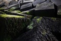 Artistic image of big stoned cubes on the seaside.