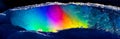 A highly coloured image of rainbow colours shown in a freezing iceberg landscape