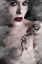 Artistic image of tattooed woman with a flower tattoo black tribal