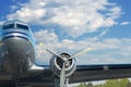 WWII Warbird headon with engine and wing in blue sky with clouds