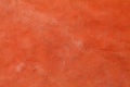 Artistic painted with fading orange red color on rough surface concrete wall for graphic design background Royalty Free Stock Photo