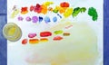 Artistic palette with multi-colored paints on white background. Royalty Free Stock Photo