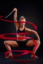 Artistic photo of gymnast girl with ribbon