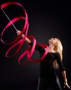 Artistic photo of rhytmic gymnast with ribbon