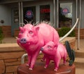 Artistic pink pigs in front of a tour business in sedona