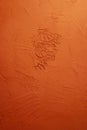 Artistic plaster trowel pattern on an orange wall with texture pattern Royalty Free Stock Photo