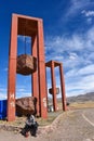 Artistic sculpture of three massive hanging rock blocks, at the entrance to Tiwanaku archaeological site, near La Paz, Bolivia