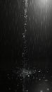 Artistic shot of rain falling on black surface, creating splash, reflections. Water drops falling as heavy rain. Abstract Royalty Free Stock Photo