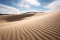 artistic shot of sand dunes, focusing on the pattern created by the wind