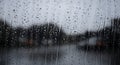 An artistic shot of a window covered in raindrops, creating a blurred and abstract view of the outside world. Royalty Free Stock Photo