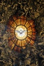 Artistic stained glass window of the Holy Spirit depicted with a dove inside the basilica of San Pietro in Rome