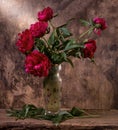 Artistic still life with red peonies in vase
