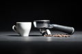 Artistic studio shot of holder for coffee machine, white cup and Royalty Free Stock Photo