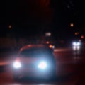 Artistic style - Defocused urban abstract texture, blurred background with bokeh of city lights from car on street at night, vint