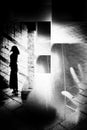 Artistic surreal black and white rough textured collage of silhouette of woman in urban environment