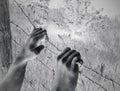 Artistic surreal tortured hands grasping desperately barbed wire