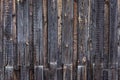 Artistic texture of an old wooden fence in black and brown tones - close-up rustic background Royalty Free Stock Photo