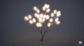 Artistic tree-shaped lamp with luminous bulbs and metal branches, illuminated in a studio setting Royalty Free Stock Photo