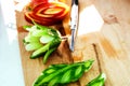 Artistic vegetable carving. A sliced cucumber in the form of a flower lies on a wooden board. Selective focus