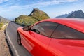 An artistic vision of a fully electric Ferrari supercar on the road