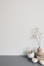 Artistic wokspace, still life. Pencils in ceramic holder. Vase with dry lunaria flowers, litttle white pumpkins, books Royalty Free Stock Photo