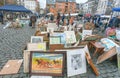 Artistic works and paintings for sale on outdoor flea market with old bargains, antique stuff, vintage decor