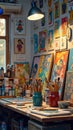 Artistic workspace with colorful paintings and brushes in a cozy studio Royalty Free Stock Photo