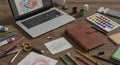 Artistic workspace featuring a laptop with digital artwork on screen, surrounded by Royalty Free Stock Photo