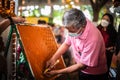 Artists carve Thai patterns on wax to make candles to worship the Buddha on Buddhist Lent Day