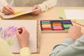 Artists drawing with soft pastels at table, closeup