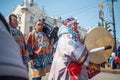 Artists of the folklore musical ensemble are walking along the street