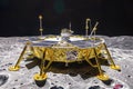 An artists interpretation of a spacecraft touching down on the moons desolate surface, with craters and scattered rocks