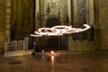 Artists juggling with two burning poi`s at fire performance. Long exposure causing painting with light Royalty Free Stock Photo