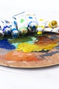 Artists oil paint tubes open and used on a wooden palette,  with mixed colours.  Art and craft supplies Royalty Free Stock Photo