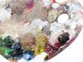 Artists palette with colors mix over white background. Royalty Free Stock Photo