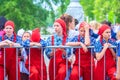 Artists of the theater group in red overalls and scarves take part in the festive procession of high school graduates