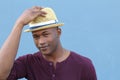 Artsy looking student saluting with his hat