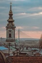 Artsy vertical shot of the Saborna church and new Ada bridge pylon in Belgrade, Serbia