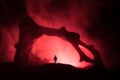 Artwork decoration with animal bone. Silhouette in an underground abandoned crypt. man standing in front of a cave entrance Royalty Free Stock Photo