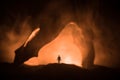 Artwork decoration with animal bone. Silhouette in an underground abandoned crypt. man standing in front of a cave entrance Royalty Free Stock Photo