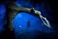 Artwork decoration with animal bone. Silhouette in an underground abandoned crypt. man standing in front of a cave entrance Royalty Free Stock Photo