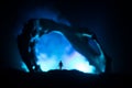 Artwork decoration with animal bone. Silhouette in an underground abandoned crypt. man standing in front of a cave entrance Royalty Free Stock Photo