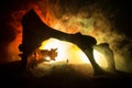 Artwork decoration with animal bone. Silhouette in an underground abandoned crypt. man standing in front of a cave entrance Royalty Free Stock Photo