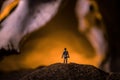 Artwork decoration with animal bone. Silhouette in an underground abandoned crypt. man standing in front of a cave entrance Royalty Free Stock Photo