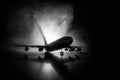 Artwork decoration. White passenger plane ready to taking off from airport runway. Silhouette of Aircraft during night time Royalty Free Stock Photo