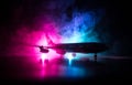 Artwork decoration. White passenger plane ready to taking off from airport runway. Silhouette of Aircraft during night time Royalty Free Stock Photo