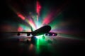 Artwork decoration. White passenger plane ready to taking off from airport runway. Silhouette of Aircraft during night time Royalty Free Stock Photo