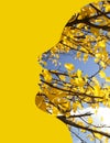 Artwork illustration of autumn tree in female face silhoette on yellow background