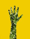 Artwork illustration of flowers in human hand silhoette shape on yellow background