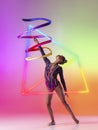 Creative artwork of prfessional female rhythmic gymnast in motion with bright ribbon over neon geometric element